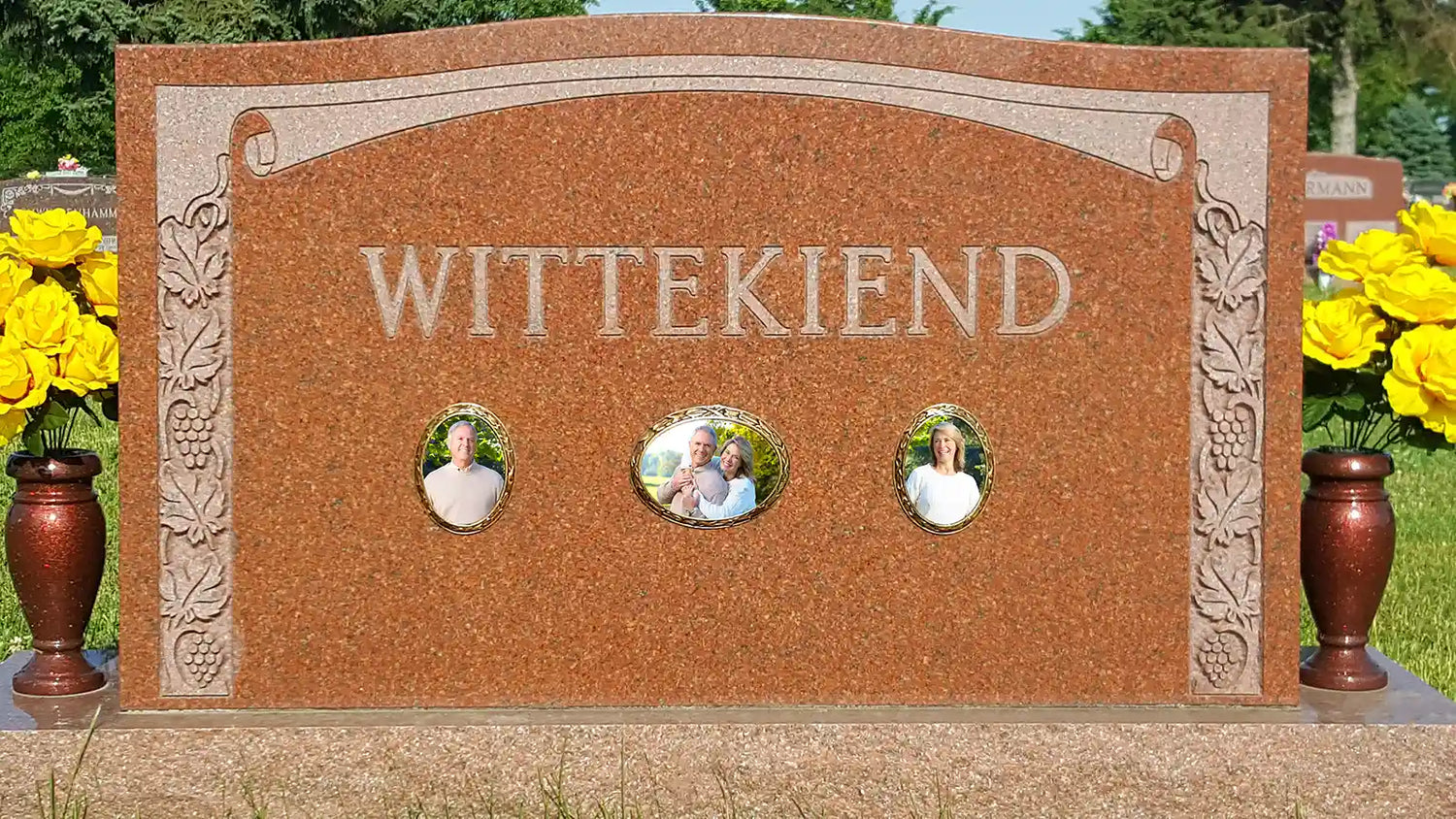 Upright Headstone with Ceramic Cemetery Pictures. Gravestone with porcelain pictures of man, woman, and couple. Ceramic memorial plaques installed on red granite headstone. Three oval memorial pictures with weatherproof frames installed on tombstone.