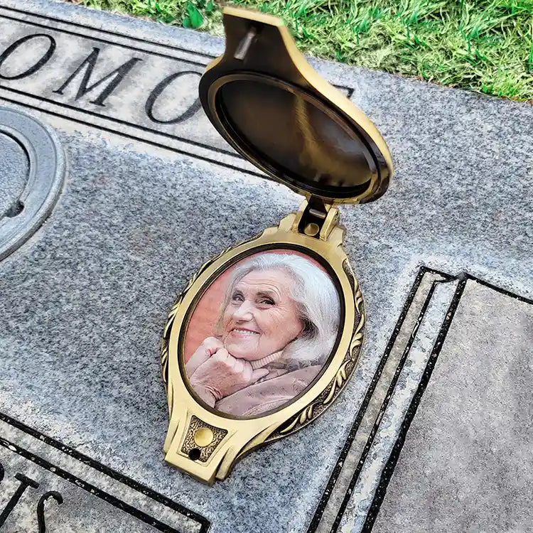 Oval bronze headstone frame with cover. Woman in weatherproof frame for cemetery with cover. Bronze waterproof frame for headstone.
